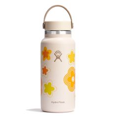 a white water bottle with yellow and orange flowers painted on it's side, in front of a white background