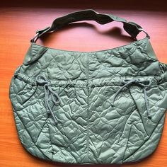 Women's Green Hobo Bag. Quilted Nylon With Two Front Pockets Adjustable With Cotton Cord Ties. Interior Fully Lined With Zippered Pocket. Small Nick On Handle As Shown In Photo. New Never Worn. Khaki Nylon Tote Bag, Casual Quilted Hobo Bag For Everyday, Casual Quilted Hobo Bag, Casual Nylon Hobo Bag For Travel, Large Capacity Nylon Shoulder Bag For Errands, Casual Nylon Hobo Tote Bag, Casual Large Capacity Nylon Diaper Bag, Large Capacity Nylon Diaper Bag, Casual Nylon Diaper Bag With Large Capacity