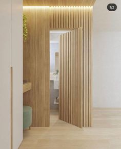 an open door leading to a bathroom with wood slats on the walls and floor