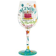 a wine glass with an image of a birthday cake on the bottom and words that say december