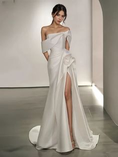 a woman in a white dress with a slit