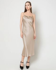 Material: 22 Momme 100% Mulberry Silk;Details: Lightly Draped Cowl Neck, Spaghetti Straps, Bias Cut, Regular Fit; The timeless minimalist silk slip dress is a versatile piece that effortlessly transitions from season to season. With its slim yet relaxed fit, delicate spaghetti straps, and a subtle cowl neckline, this silk midi dress exudes a refined elegance. Whether attending a wedding or a dinner party, it stands as a classic and sophisticated choice, radiating an intense shine that adds to it Elegant Silk Camisole Dress, Summer Slip Dress With Straight Neckline For Dinner, Chic Solid Color Bias Cut Slip Dress, Elegant Formal Solid Color Slip Dress, Elegant Formal Slip Dress, Fitted Silk Slip Dress In Solid Color, Silk Spaghetti Straps Dress For Daywear, Elegant Silk Dress With Spaghetti Straps For Daywear, Elegant Silk Satin Dress For Daywear