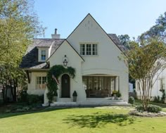 a large white house with a flag on the front door and windows in the back