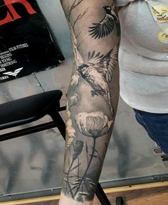 a person with a bird tattoo on their arm