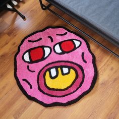 a pink rug with an angry face drawn on it