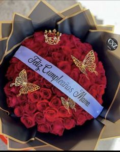 a bouquet of red roses with butterflies on it and a ribbon that says, city campus mum