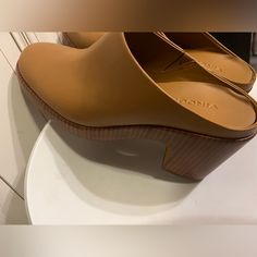 Vince. Women's Navina Platform Clog Tan Leather Mule Shoes Size 7.5 M Formal Slip-on Clogs With Reinforced Heel, Chic Slip-on Clogs With Reinforced Heel, Modern Slip-on Heels With Wooden Heel, Chic Slip-on Platform Mules, Leather Clogs With Removable Insole And Almond Toe, Leather Platform Heels Slip-on, Luxury Brown Clogs With Round Toe, Leather Clogs With Wooden Heel And Almond Toe, Leather Platform Clogs With Open Heel