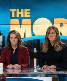 two women sitting at a table in front of a news set with the morning logo behind them