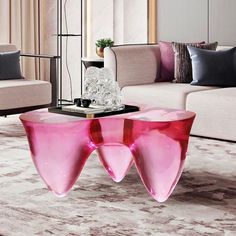 a living room filled with furniture and a pink table on top of a carpeted floor