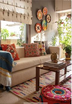 a living room filled with furniture and lots of pillows on top of it's walls