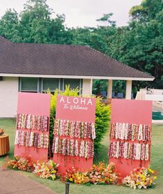 a couple of red signs sitting on top of a lush green field covered in flowers