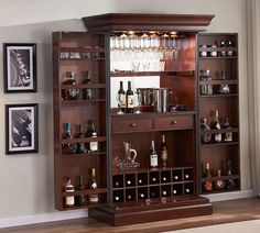 an entertainment center with wine glasses and liquor bottles