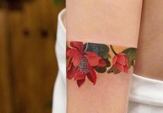 a woman's arm with a flower tattoo on the left side of her arm