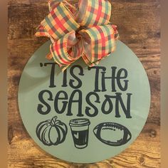 a sign that says it's the season to go with a bow on top