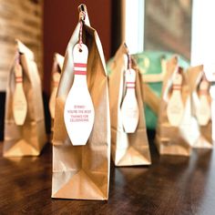 three brown paper bags with bowling pins on them