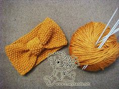 two skeins of yarn and a ball of knitting needles