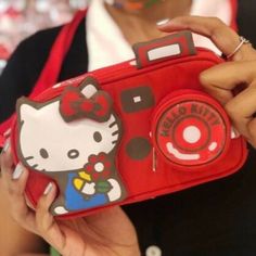 Picture Yourself In This Supercute Hello Kitty Camera Bag! Made In Collaboration With Our Friends Le Sportsac To Celebrate Hello Kitty's 45th Anniversary, This Product Is Limited Edition. 3.75" H X 7" W X 2" Features A Zip Top Main Closure, Exterior Front Coin Pocket With Zip Closure, And Interior Back Wall Open Pocket. There Are Also Two Strap Options: Attached 14" Short Strap, Plus A 40" Long Extension Strap With Quick Release Clips On Each End (For Crossbody Wear). Cute Red Satchel Bag, Cute Red Shoulder Bag, Red Handheld School Bag, Red School Bag With Detachable Strap, Cute Red Satchel For Everyday Use, Cute Red Satchel For Daily Use, Cute Red Shoulder Bag For Everyday Use, Portable Red Rectangular Pouch, Cute Red Rectangular Satchel