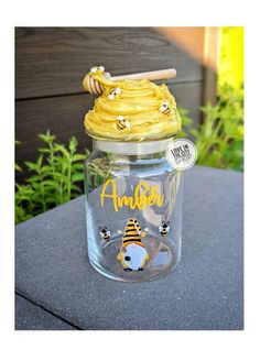 a glass jar filled with honey sitting on top of a table