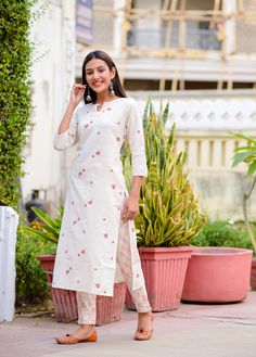 Off-white printed straight calf length kurta, has a keyhole neck, three-quarter sleeves, straight hem, side slits. Off-white printed trousers, has partially elasticated waistband, slip-on closure.   Size  & Fit:  The model (height 5'8") is wearing a size S.   Material & Care: Top fabric: 100% Cotton Bottom fabric: Cotton Blend Hand-wash   US Size Conversion: XS = 0, S = 2-4, M = 6-8, L = 10, XL = 12-14, XXL = 16, XXXL = 18 Size Guide in inches (garment measurements): Sizes, US Sizes, Bust, Waist Designer Kurtis Online, Resort Chic, Punjabi Dress, White Kurta, Keyhole Neck, Set Style, Printed Trousers, Kurta With Pants, Colored Pants