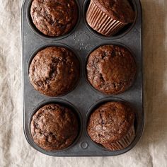 chocolate muffins in a baking pan on a table