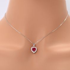 Lab Grown Ruby Heart Necklace For Women Discover our minimalist dainty necklace featuring a 7x7 mm heart shaped Ruby in the center accented with 28 pieces of round cut moissanite stones of 1.4 mm around the main stone creating a halo necklace design. This love necklace is carefully set in Rhodium over 925 Sterling Silver weighing a total of 1.63 ct. The beautiful design of this heart pendant makes a great gift for woman that she can adore around her neck. Love Necklace Halo Ruby Pendant Gift This created ruby heart pendant is a great way to express your love. Halo pendants are not just any regular pendants, they have a deeper meaning attached to them making them a special gift for her. The halo represents the embrace of your affection, enveloping your partner's neck with a dazzling display Dragon Goddess, Ruby Heart Necklace, Ruby Heart Pendant, Galaxy Stuff, Red Lab, Ruby Heart, Deeper Meaning, Halo Necklace, Special Gifts For Her