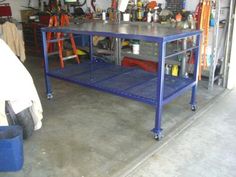 a blue workbench in a garage with tools on the shelves and other items