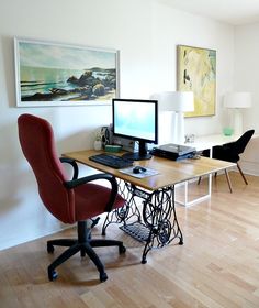 a computer desk with two monitors on top of it and a chair next to it