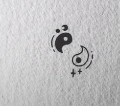 the symbol for yin is shown in black on white paper, with an image of a person's head