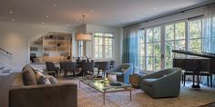 a living room filled with furniture and a piano