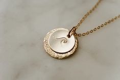 Our "Sun and Sea Necklace" represents two of nature's most beautiful offerings - the sun and sea! They are a perfect pairing, just like you and your loved one. Remind them that they are your sunshine to your sea. Available in gold-filled, rose gold-filled, or sterling silver, this necklace is designed to last. Hand-stamped double discs with sunburst and wave designs in your choice of material—rose gold fill, yellow gold fill, or sterling silver—hang from a matching cable chain. Sea Necklace, Dainty Gold Necklace, Wave Design, Dainty Necklace, Cable Chain, Perfect Pair, Sun, Hand Stamped, Gold Filled