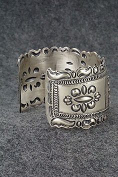 This stunning and intricate sterling silver bracelet was made by Navajo silversmith Eugene Charley. The inside is signed and stamped sterling.Size: 6" (will fit up to a 7 3/8" wrist)Gap: 1 3/8"Width: 1 1/2"Free shipping on all orders! We ship with USPS and always include tracking. All orders ship within a day of payment.Returns are accepted up to 30 days after you receive your order. Just send us a message. Our shop offers cash back or store credit. The item must be returned in new condition. Southwestern Engraved Sterling Silver Bracelet Gift, Engraved Sterling Silver Bracelet Gift, Antique Silver Adjustable Cuff Bracelet With Intricate Design, Southwestern Sterling Silver Jewelry In Silver, Southwestern Sterling Silver Bracelet Stamped 925 As Gift, Adjustable Ornate Sterling Silver Bangle, Adjustable Antique Silver Cuff Bracelet With Intricate Design, Ornate Sterling Silver Bangle Jewelry, Ornate Antique Silver Sterling Bracelets