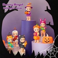 there are many figurines on top of the halloween cake, and one is holding a candy bar