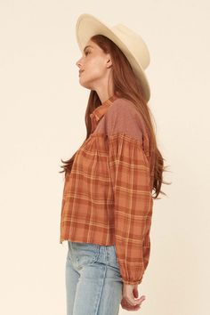 Plaid peasant top. Contrasting gingham yoke. Collared neckline. Button-front closure with wood buttons. Long bubble sleeves with elastic cuffs. Drop shoulder. Ruffle trim. Raw-edge hem. Loose fit. 100% Cotton. Imported. Designed in LA. Model wears size S. Fall Gingham Button-up Blouse, Gingham Button-up Tops For Fall, Fall Gingham Button-up Tops, Fall Gingham Tops With Buttons, Casual Button-up Peasant Top For Fall, Casual Gingham Blouse For Fall, Peasant Style Brown Long Sleeve Tops, Peasant Style Cotton Blouse For Fall, Casual Brown Cotton Peasant Top