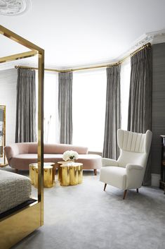 an elegant bedroom with gold accents and white furniture