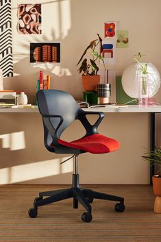 an office chair sitting on top of a wooden floor next to a desk with books