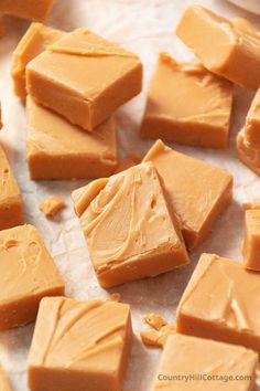 several pieces of caramel fudge sitting on wax paper