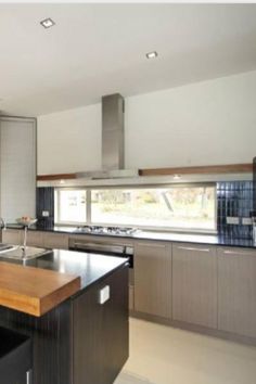 a modern kitchen with an island and stainless steel appliances