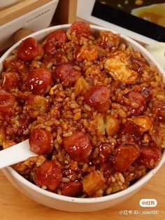 a bowl filled with lots of food sitting on top of a wooden table next to a box