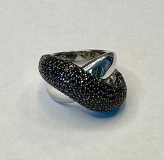 This listing is for a stunning ring crafted of solid sterling silver and featuring a top of pave set black diamonds as shown in the photos. The ring is in excellent condition. Crafted of solid sterling silver (hallmarked 925) the total weight is approximately 14 grams. Currently a size 7 but can be resized by your local jeweler if needed. Unfortunately, I'm no longer able to offer sizing or engraving services on sterling jewelry. Includes a nice gift box. I happily use recycled shipping products Luxury Silver Rings With Black Spinel, Luxury Black Spinel Silver Rings, Silver Sterling Silver Ring With Black Diamonds, Silver Sterling Silver Diamond Ring With Black Diamonds, Silver Rings With Pave Setting For Evening, Luxury Silver Diamond Ring With Black Diamonds, Silver Ring With Polished Finish For Evening, Silver Ring With Black Diamonds For Anniversary, Silver Rings With Black Diamonds For Anniversary