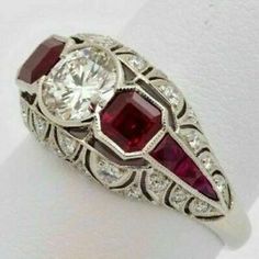 an antique style ring with two stones and diamonds