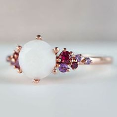 Beautiful handmade item! Here, on Etsy made as simulation only-just resin and white color.  Breastmilk Ring made with white gold plated sterling silver or plated with rose or yellow gold. Opal effect breastmik 7mm diamond shaped stone. Any size available. Rose gold,  or white gold plated options.  Pearl powder or opal effect can be added to this fine breastmilk ring.  Symbolic of the little diamond you brought into this world, our breastmilk stone ring shines bright. Beautiful inlaid cubic zirconia surround and accentuate your breastmilk stone while a skin-friendly 925 sterling silver ring core.  To see our full breastmilk Ring collection, please click here: https://www.etsy.com/ca/shop/KeepsakeMom?ref=simple-shop-header-name&listing_id=1095328032&section_id=24695275 To see All our items, White Enamel Open Ring For Anniversary, White Opal Dainty Birthstone Ring, White Dainty Opal Birthstone Ring, Fine Jewelry White Cabochon Moonstone Ring, White Cabochon Moonstone Ring In Fine Jewelry Style, White Sterling Silver Enamel Ring As Gift, White Enamel Sterling Silver Ring As A Gift, White Cabochon Moonstone Ring Fine Jewelry, White Fine Jewelry Round Ruby Ring