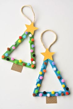 two christmas tree ornaments made out of construction paper and colored beads, hanging from twine strings