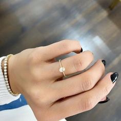 a woman's hand with a ring on it