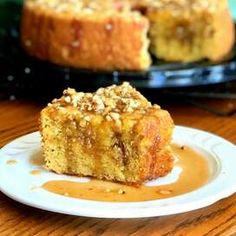 a piece of cake sitting on top of a white plate covered in caramel sauce