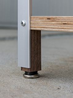 a close up of a wooden bench with metal posts