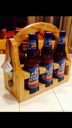 six bottles of beer in a wooden holder