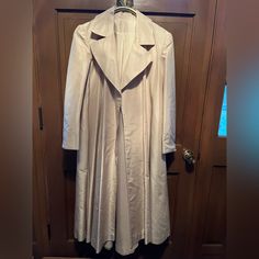 Silk Evening Coat. 100 Percent Real Silk. Beautiful Cream Color. Pristine Condition. No Marks Or Signs Of Wear. Size Is Medium. The Design Is A-Line So It Has A Generous Flared Fit. Single Breasted Silk Outerwear With Long Sleeves, Single-breasted Silk Outerwear With Long Sleeves, Single-breasted Long Sleeve Silk Outerwear, Single-breasted Silk Long Sleeve Outerwear, Fitted Silk Outerwear With Hidden Button Closure, Tailored Silk Outerwear With Long Sleeves, Tailored Silk Long Sleeve Outerwear, Elegant Winter Raincoat With Long Sleeves, Elegant Long Sleeve Winter Raincoat