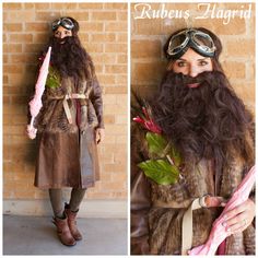 a man with long hair and beard wearing goggles is standing in front of a brick wall