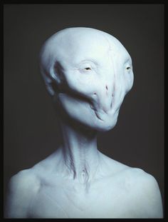 an alien man with white skin and green eyes