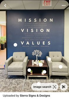 an office lobby with couches and chairs in front of a large sign that reads mission vision, value, and values